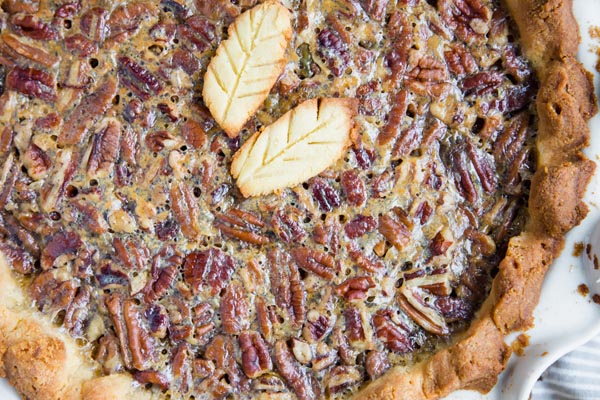a whole pecan pie with crusted pecans on top