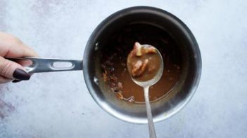 holding a spoonful of pecan pie filling