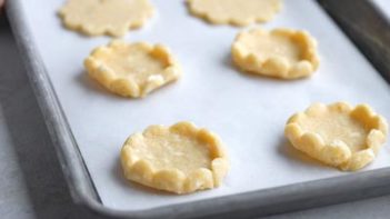 cookie dough with edges folded up on a baking tray