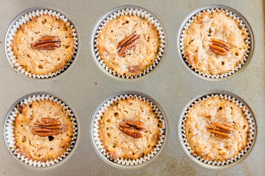 baked muffins topped with a pecan in a tray