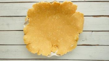 thin pie crust laying on a pie plate