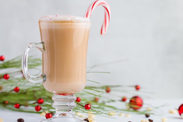 frothy peppermint keto white mocha with a candy cane
