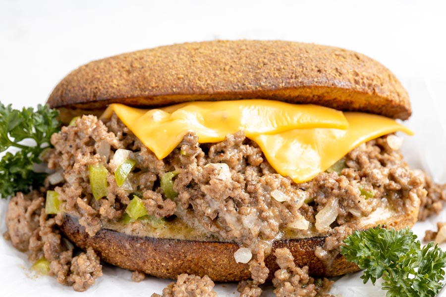 melted american cheese coming down into a philly cheesesteak sandwich made with ground beef