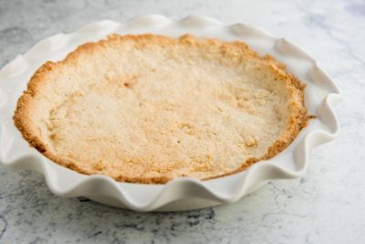 shortbread almond flour pie crust in a white pie dish