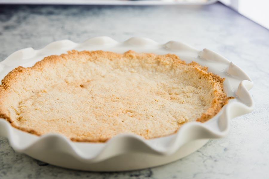keto pie crust baked in a fluted white pie plate