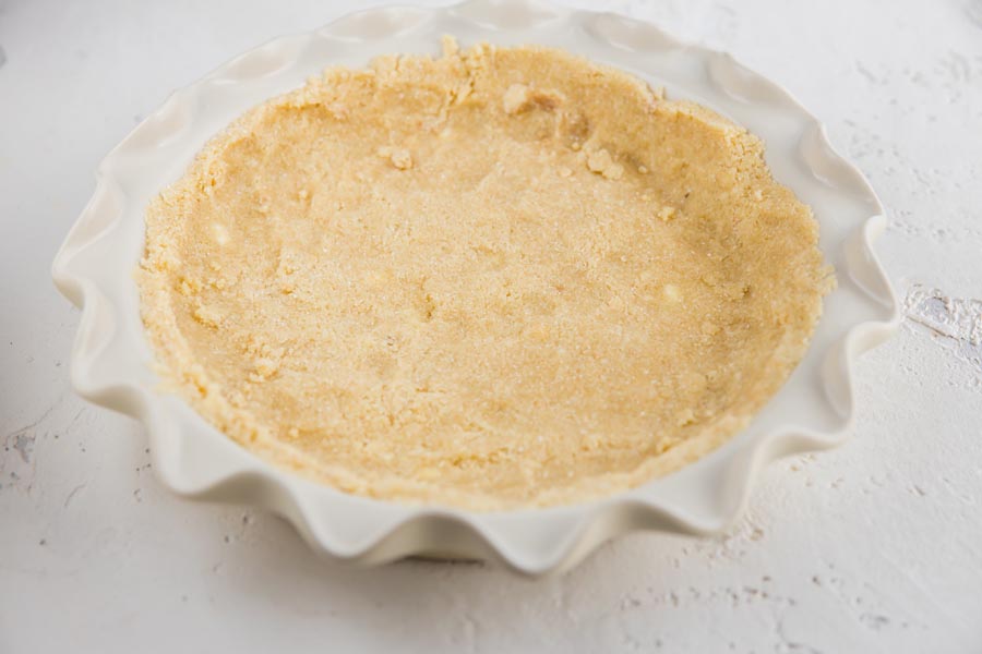 unbaked low carb pie crust pressed into a white pie plate