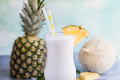 one pina colada in a hurricane glass garnished with pineapple