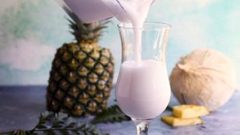 pouring pina colada into a glass