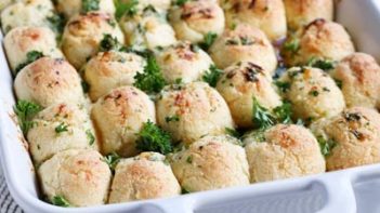 pull apart bread rolls in a row on a casserole dish