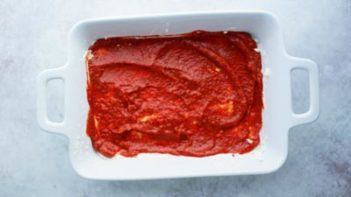 red sauce spread in a white casserole dish