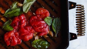 simmering tomatoes with broth and basil