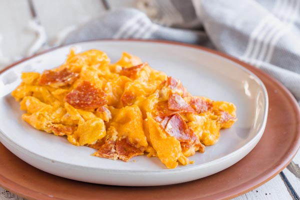 scrambled eggs mixed with pepperoni on a plate