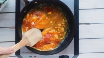 scrambling eggs with a wooden spatula