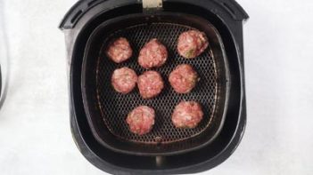 keto pizza meatballs in an air fryer basket