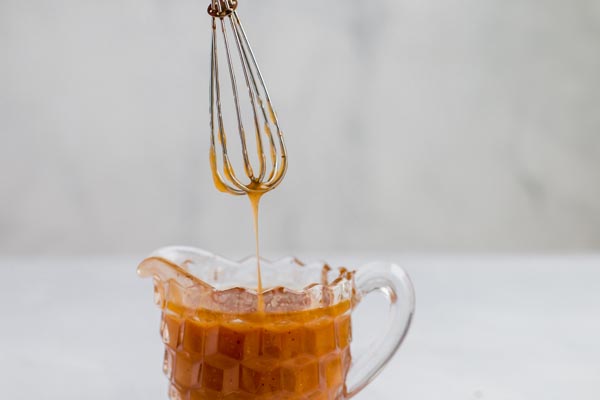 salted caramel syrup dripping from a whisk