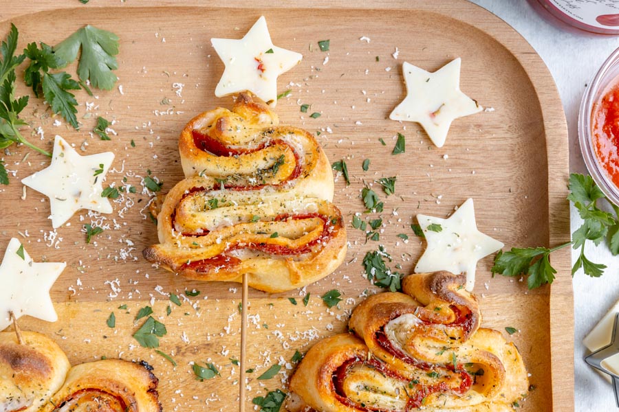 Puff pastry trees filled with pizza and topped with stars made of pepper jack cheese.