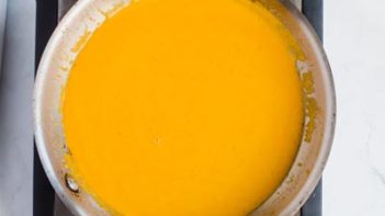 keto pumpkin sauce thickening in a skillet