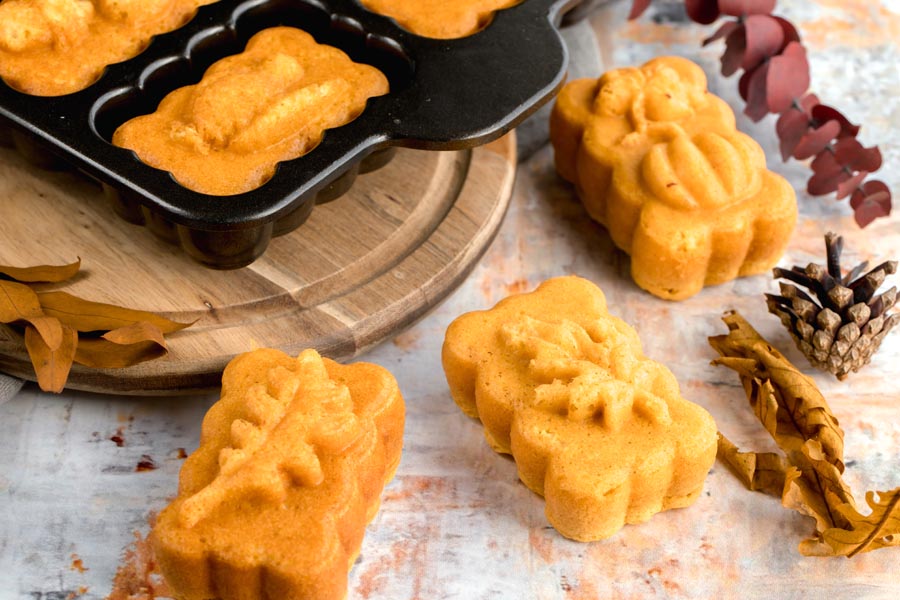 a mini harvest loaf pan with a few pumpkin loaves in it