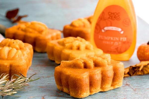 thick pumpkin loaf next to pumpkin pie syrup