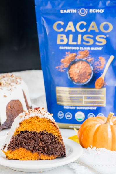 a slice of marbled bundt cake in front of a bag of cacao bliss