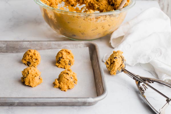 pumpkin cookies scooped on a tray