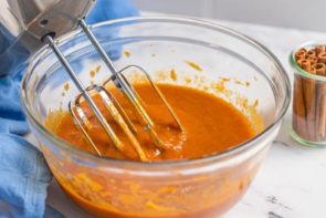 mixing wet ingredient and pumpkin with an electric mixer