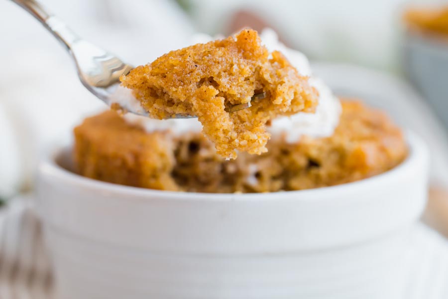 a fork holding a bite of airy pumkin cake