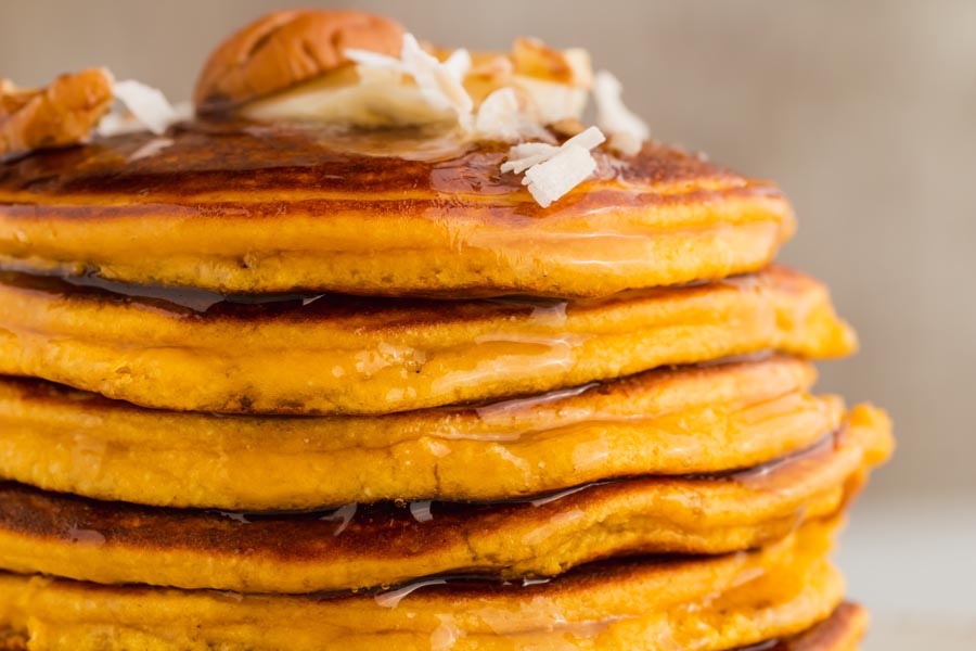 close up of syrup dripping from keto pumpkin pancakes