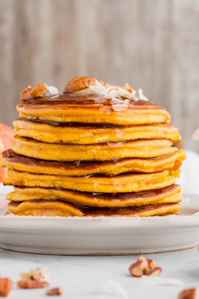 syrup dripping down from a large pancake stack