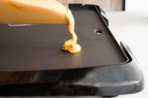 keto pancakes cooking on an electric griddle