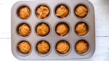 muffin batter in a bowl with egg shells next to it