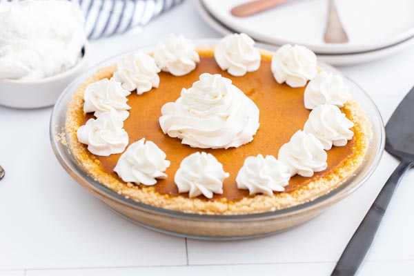 a whole pumpkin pie with whipped cream on top