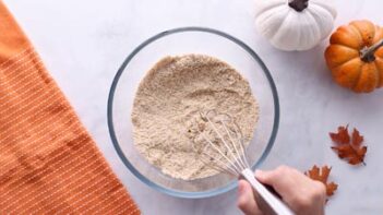 Annie's hand (from ketofocus) whisking dry ingredients in a bowl.