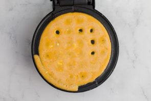 pouring chaffle batter on waffle maker