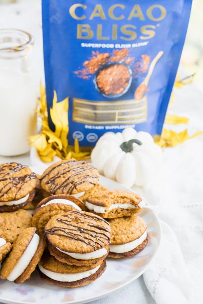 a blue bag of cacao bliss sits behind a plate of chocolate covered whoopie pies