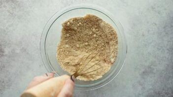 whisking dry ingredients in a glass bowl