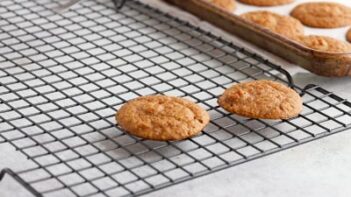 two cookies cooling on a cooling rack