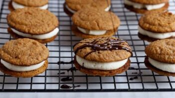 drizzling melted chocolate on top of a whoopie pie in the center