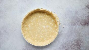 unbaked pastry crust into a tart pan