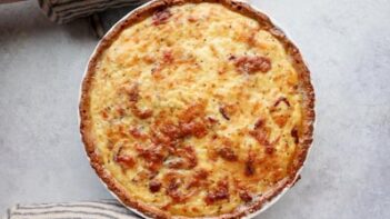 placing a baked quiche on a hot pad to cool