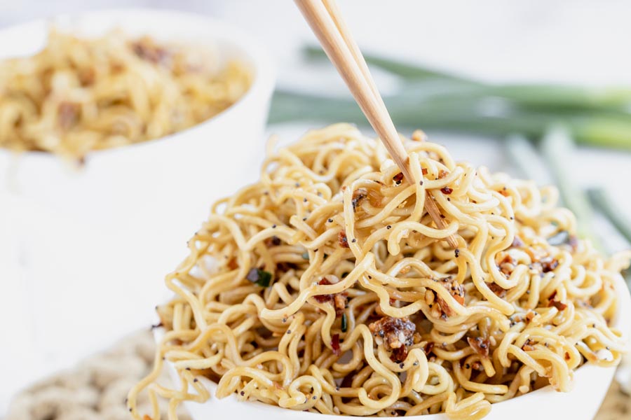 chopsticks poking into a bowl of ramen