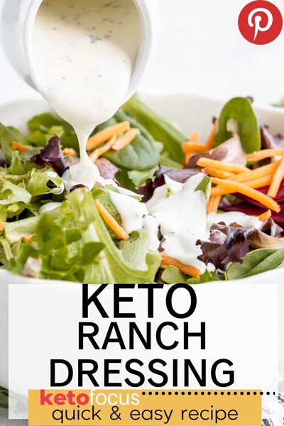 pouring creamy ranch dressing on a fresh salad of lettuce and carrots