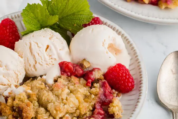 three scoops of ice cream with raspberry crumble