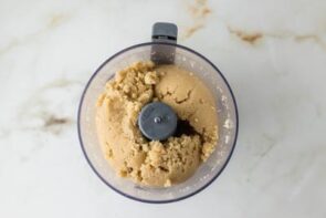 Almond flour pie crust ingredients blended in a food processor until the mixture resembles coarse crumbs.