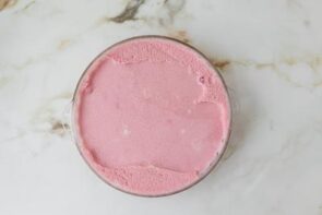 The no-bake keto raspberry marshmallow cream pie filling spread evenly into the prepared almond flour crust.