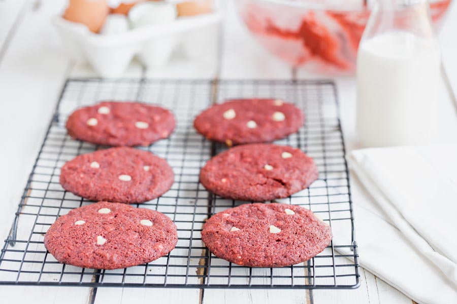 white chocolate chip red velvet cookies on a wire rack