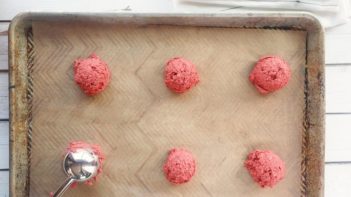 scooping cookie dough on top a baking tray