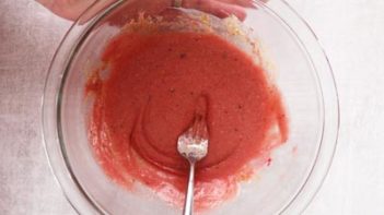 red velvet mug cake batter in a glass mixing bowl
