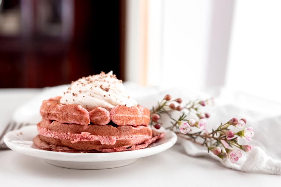 pink waffles on a table with a white tablecloth