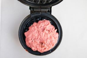 keto red velvet waffle batter in a waffle maker